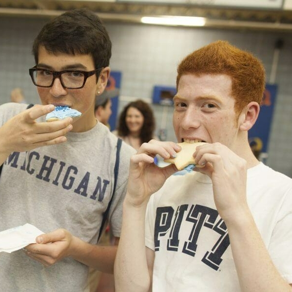 Two boys eating a cookie