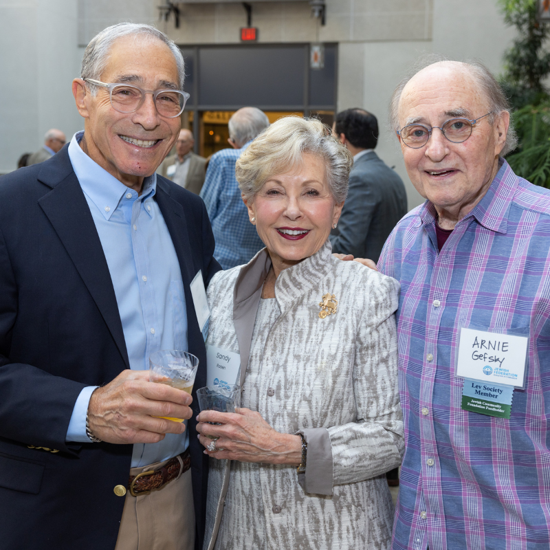 three people standing together smiling