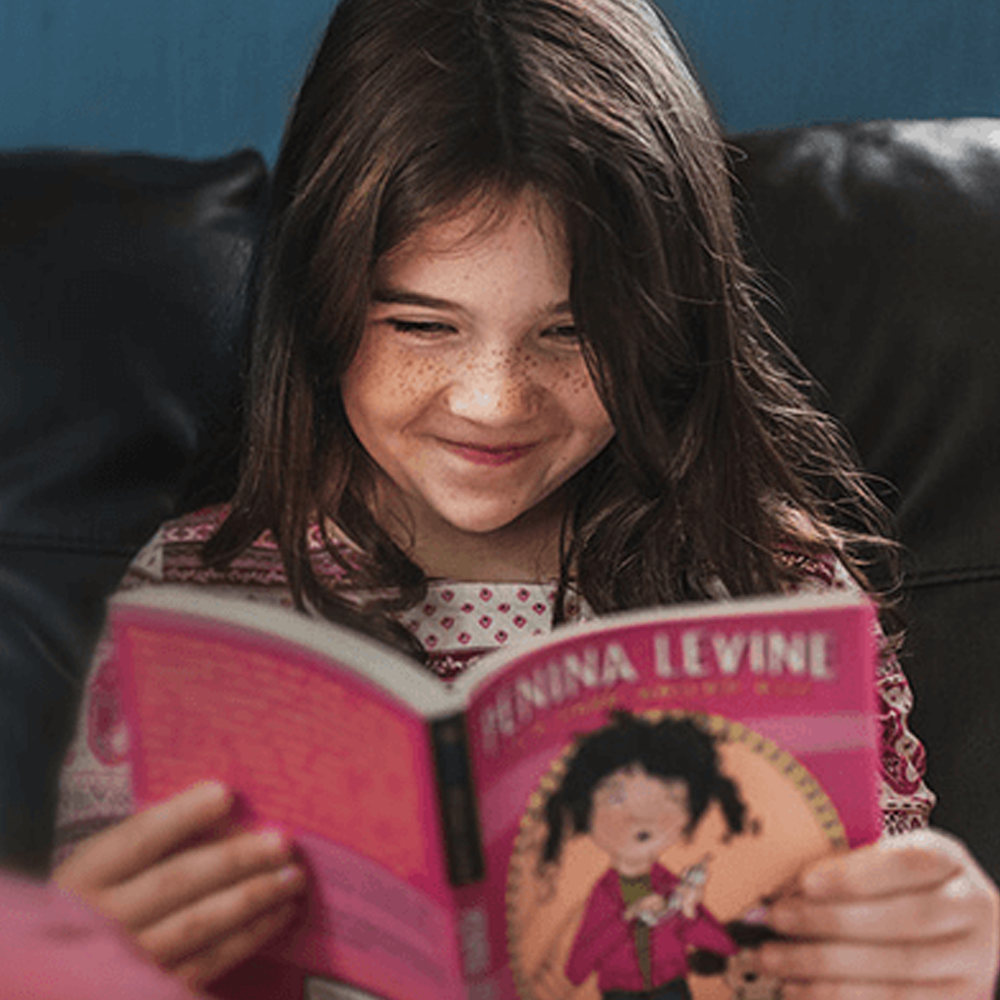 PJ Library young girl reading book