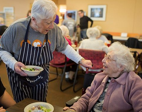 Volunteer Serving Resident at Riverview Towers