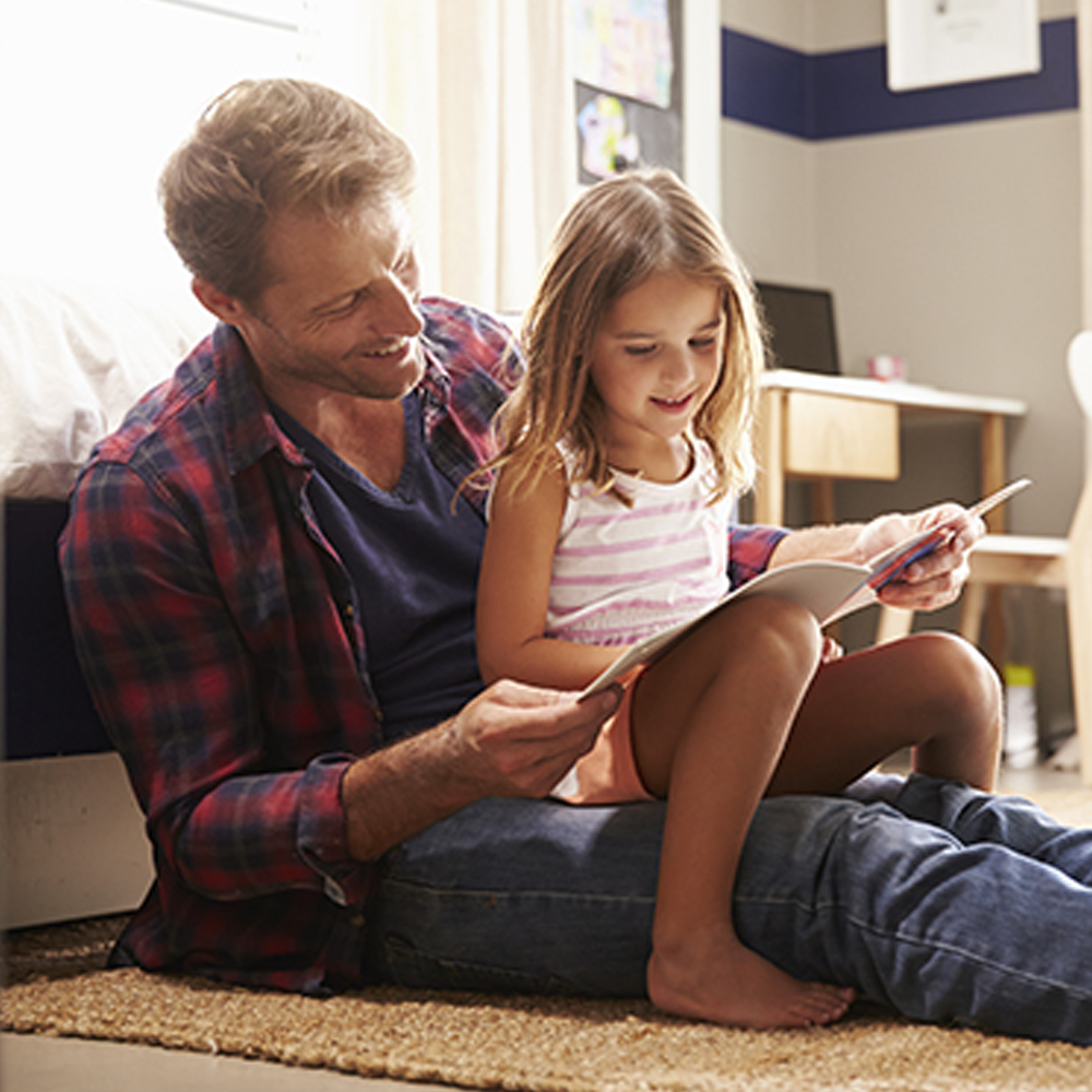 father reading to daughter