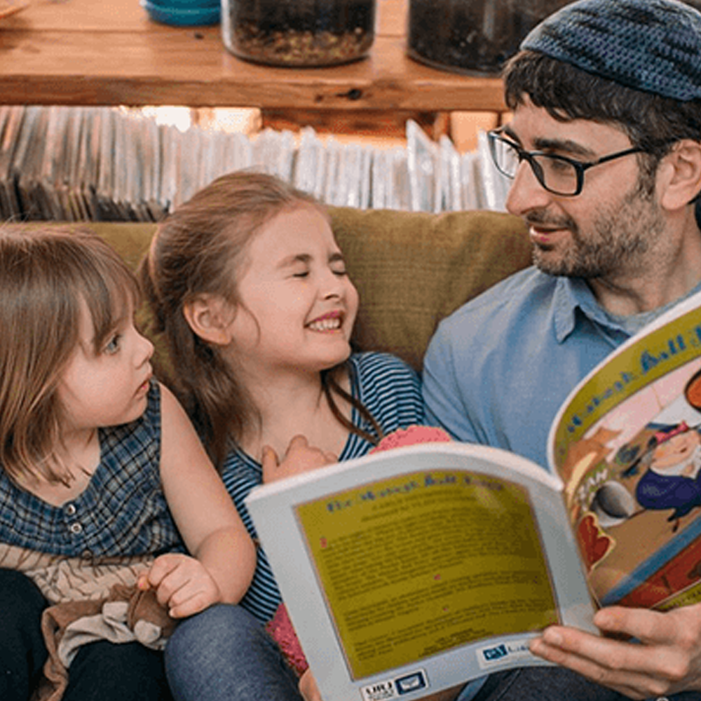 father reading to girls