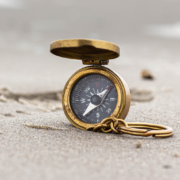 compass on a sandy beach